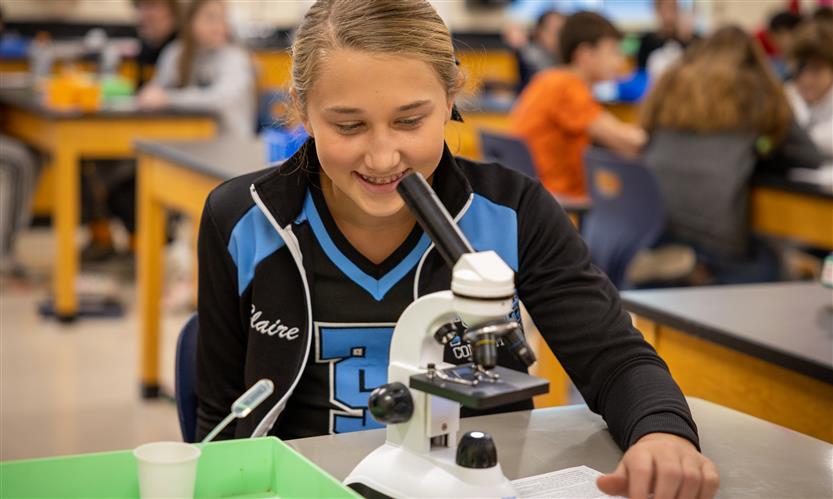 Students use microscopes in science class